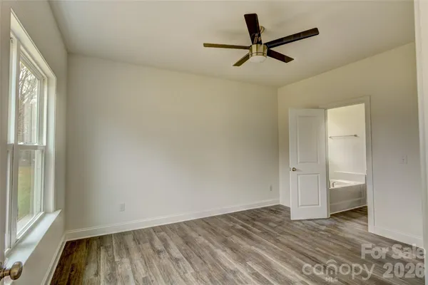 a view of a livingroom with a hardwood floor and a ceiling fan
