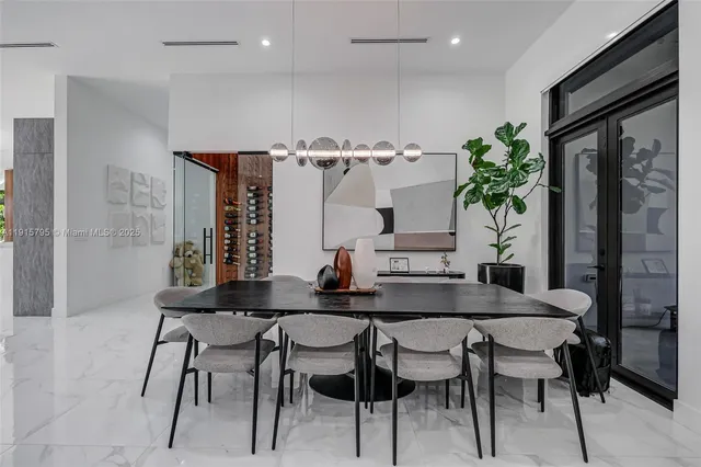 a living room with patio furniture and a flat screen tv
