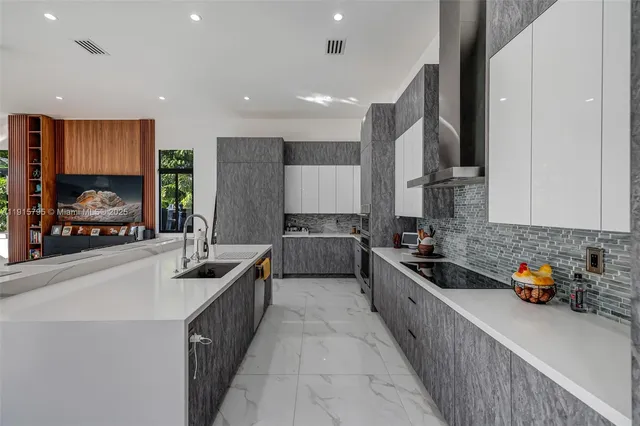 a kitchen with stainless steel appliances a refrigerator sink and cabinets