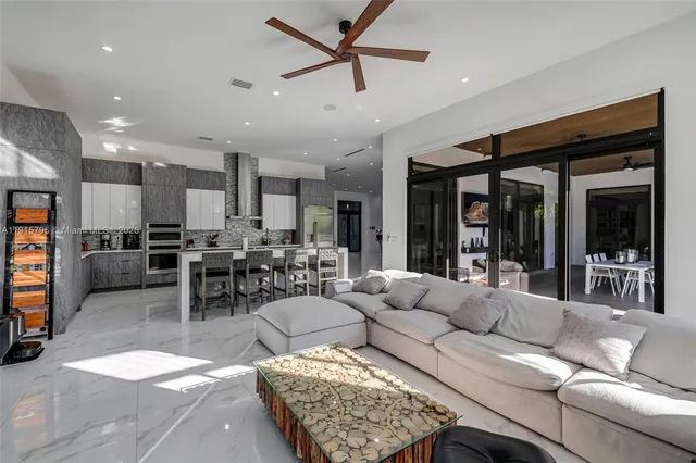 a large kitchen with stainless steel appliances lots of counter space and a sink
