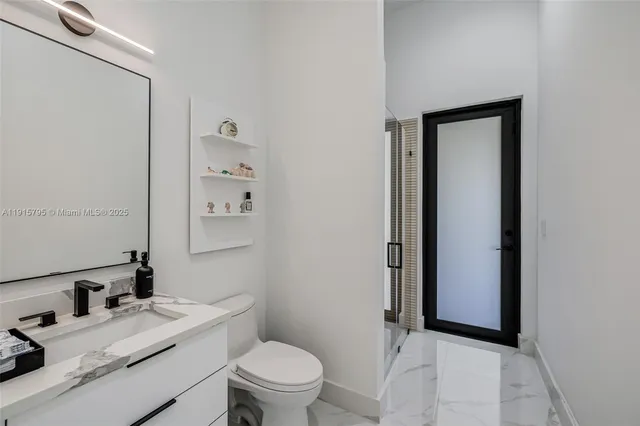 a bathroom with a sink toilet and a mirror