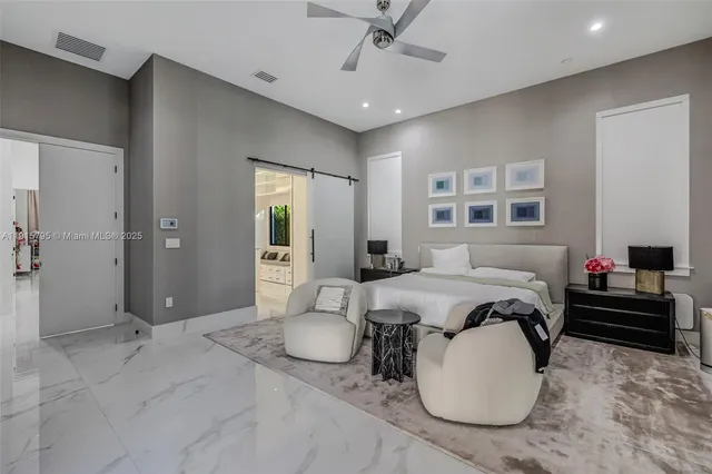 a bathroom with a granite countertop shower a toilet and a window