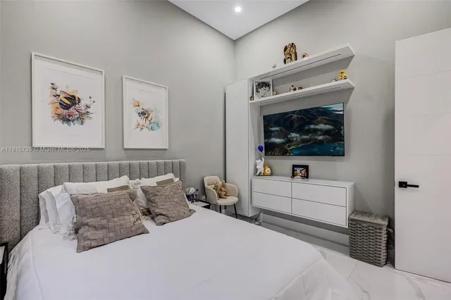 a view of a kitchen with a sink and dishwasher a refrigerator with white cabinets