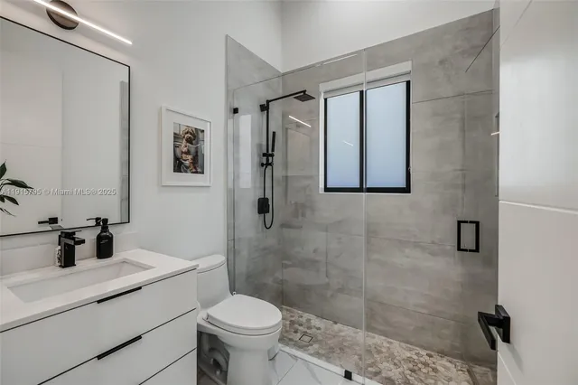 a bedroom with a bed and a view of bathroom