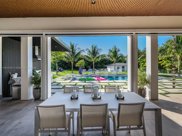 a aerial view of a house with a yard and potted plants