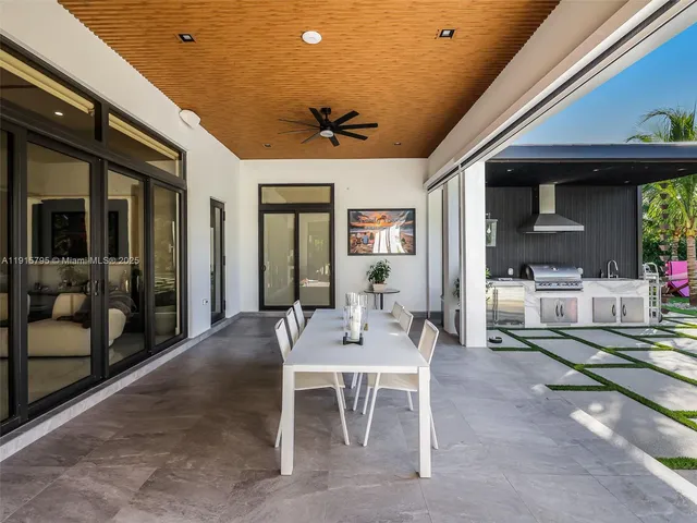 an aerial view of multiple houses with a yard