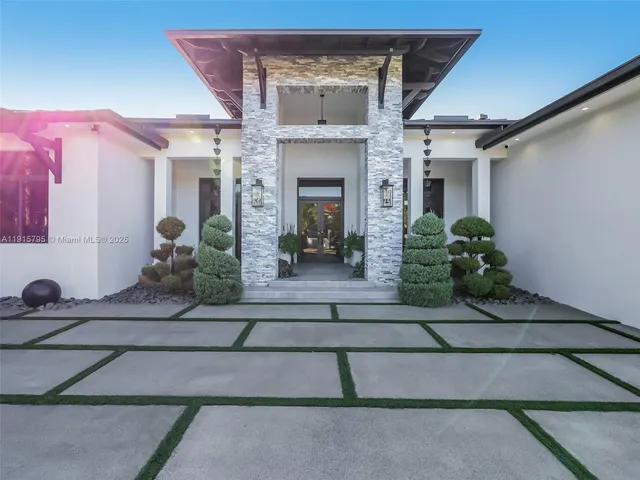 a living room with furniture and a table with potted plants