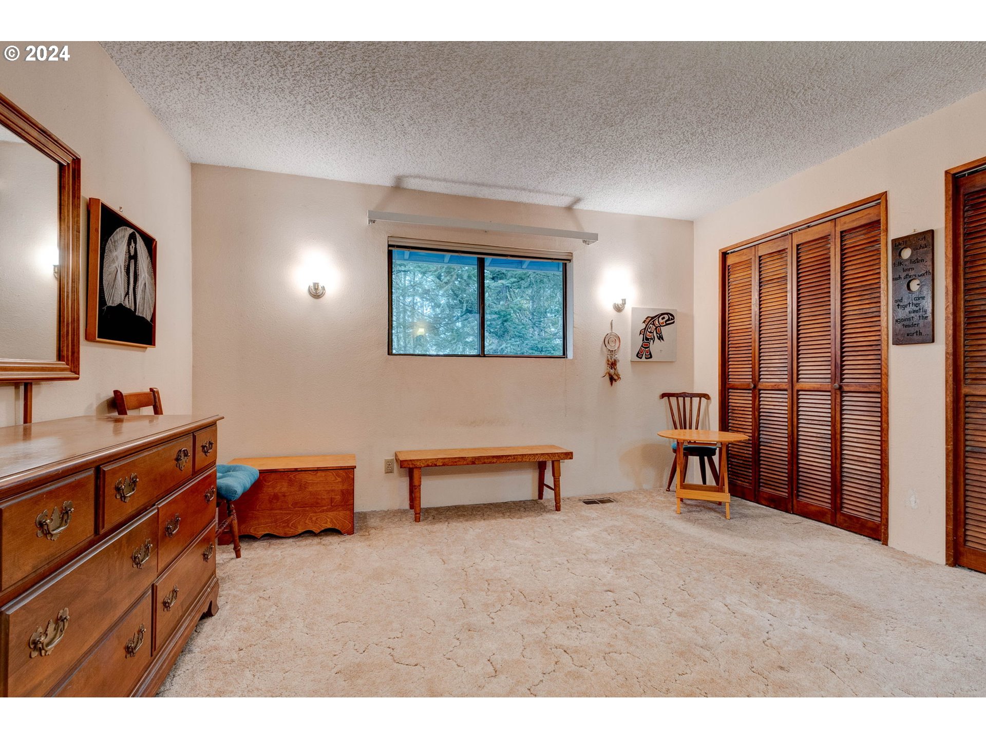 5634 South Whiskey Hill Road Hubbard, OR 97032 - Photo 18 of 48 a spacious bedroom with a bed and a tv in it