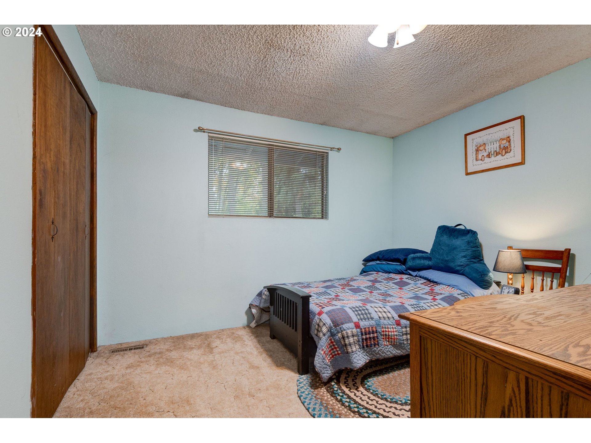 5634 South Whiskey Hill Road Hubbard, OR 97032 - Photo 22 of 48 a bedroom with a bed and a cabinet