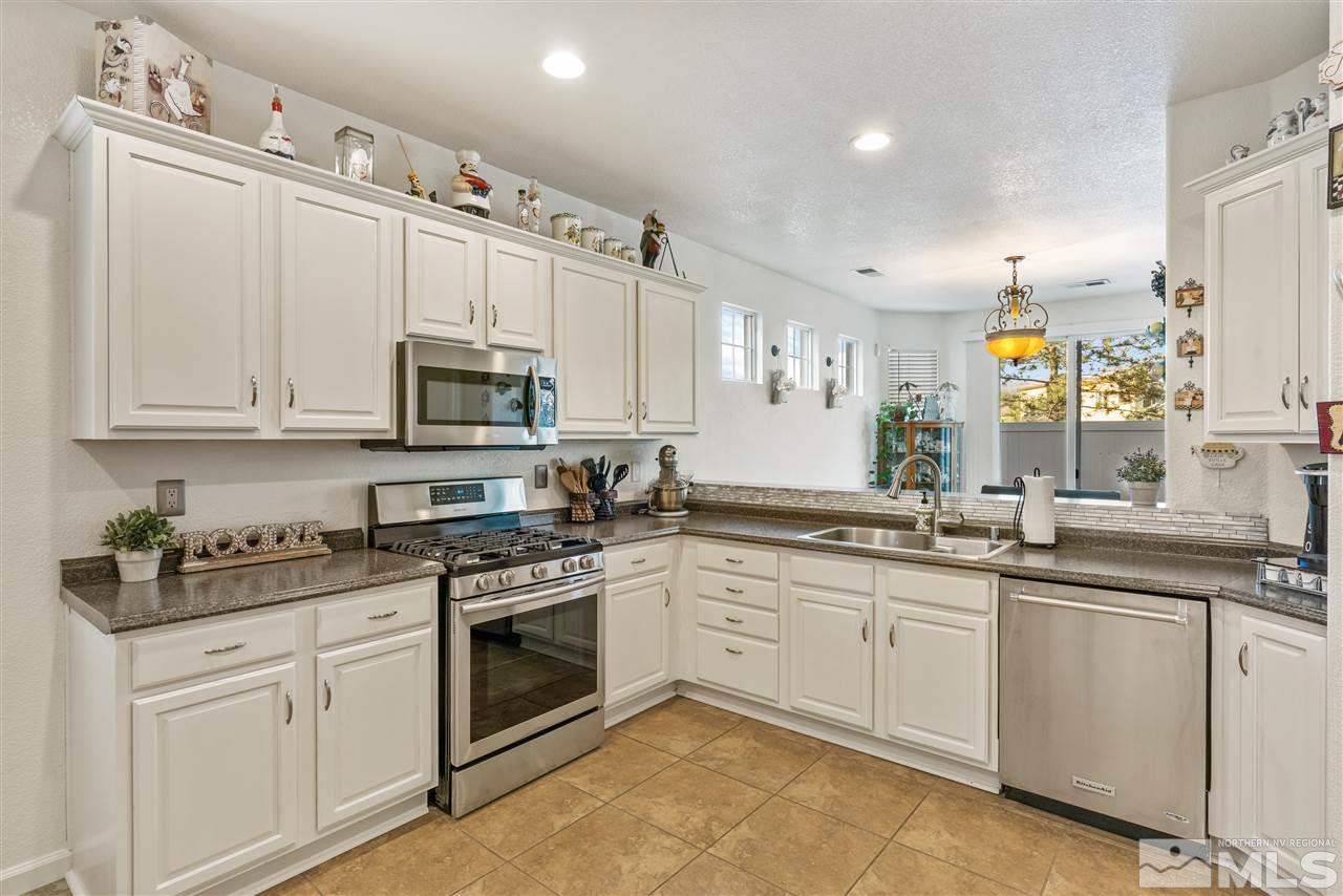 1859 Resistol Drive Reno, NV 89521 - Photo 10 of 33 a kitchen with white cabinets stainless steel appliances and sink