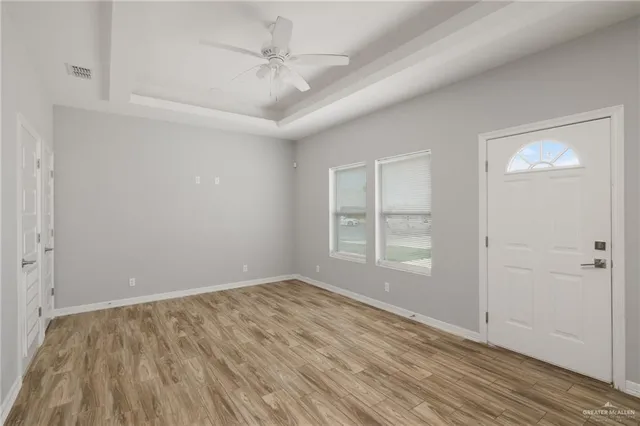 wooden floor in an empty room with a window