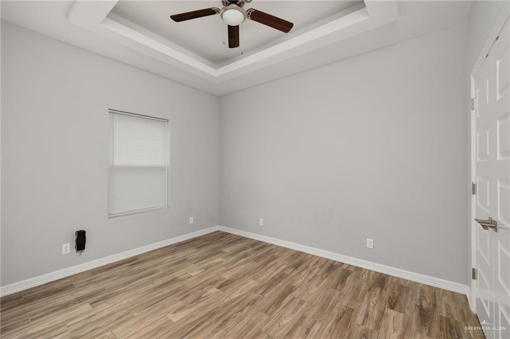611 Cameron Street Progreso, TX 78579 - Photo 8 of 10 an empty room with a window and a ceiling fan