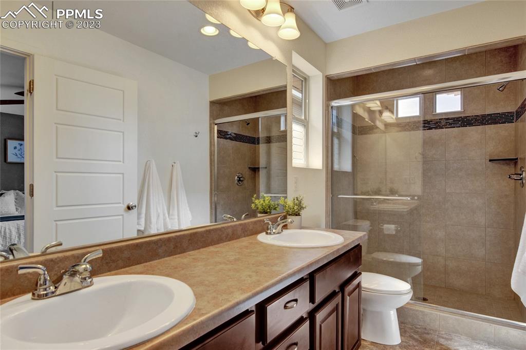 4118 Elegant Street Castle Rock, CO 80109 - Photo 17 of 26 a bathroom with a sink a toilet and shower