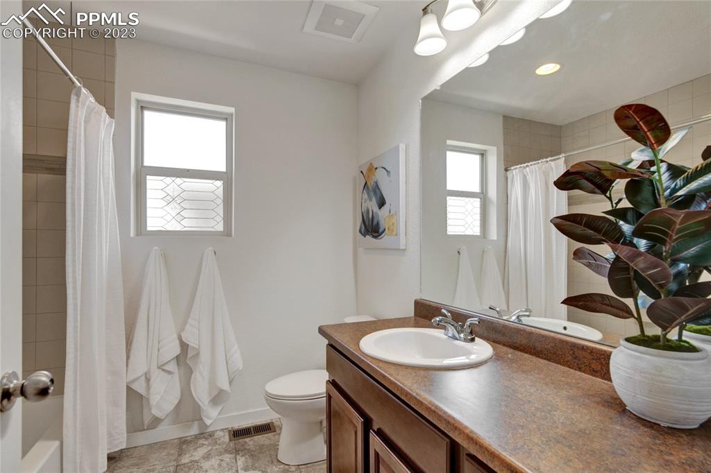 4118 Elegant Street Castle Rock, CO 80109 - Photo 20 of 26 a bathroom with a sink a toilet and a mirror