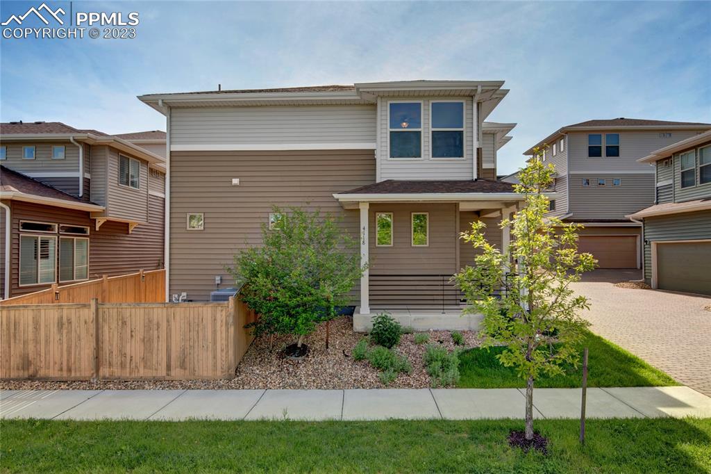 4118 Elegant Street Castle Rock, CO 80109 - Photo 2 of 26 a front view of a house with a yard