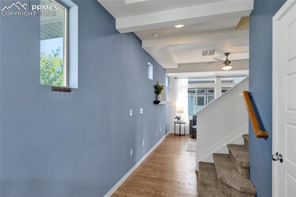 4118 Elegant Street Castle Rock, CO 80109 - Photo 5 of 26 a view of a hallway with wooden floor and staircase