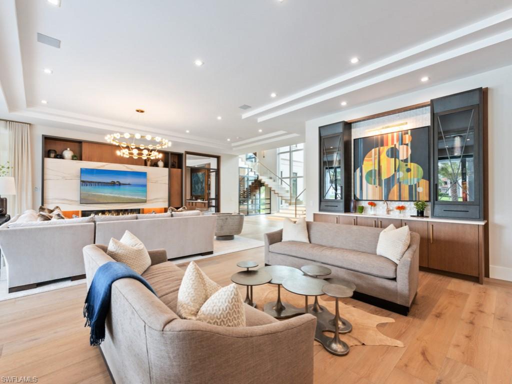 349 Colony Drive Naples, FL 34108 - Photo 12 of 48 Living room with light hardwood / wood-style flooring and a chandelier