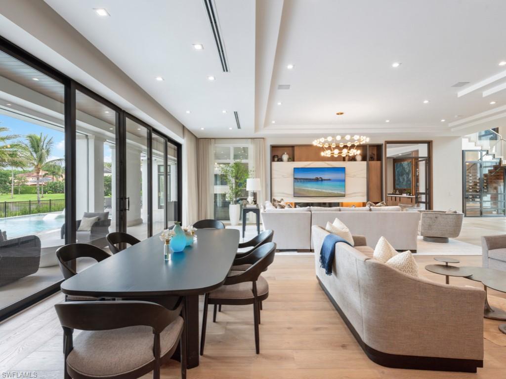 349 Colony Drive Naples, FL 34108 - Photo 17 of 48 Dining space featuring light wood-type flooring and a chandelier