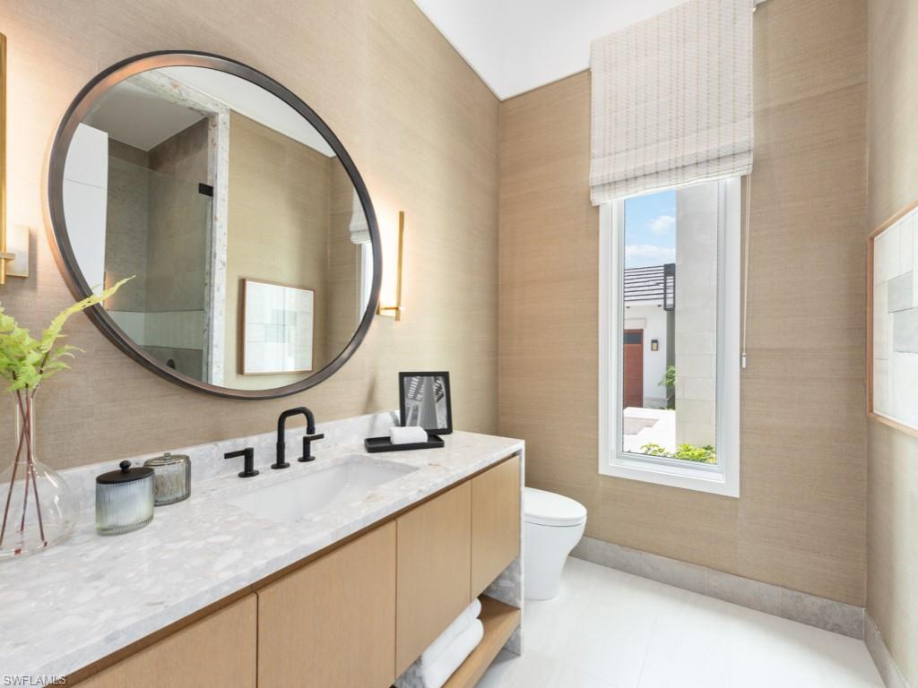 349 Colony Drive Naples, FL 34108 - Photo 28 of 48 Bathroom with tile patterned floors, a shower, toilet, and vanity