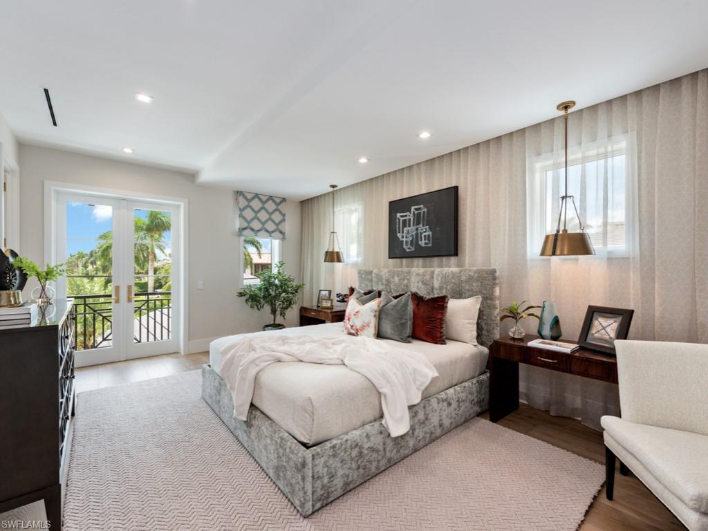 349 Colony Drive Naples, FL 34108 - Photo 29 of 48 Bedroom featuring access to exterior, hardwood / wood-style floors, and french doors