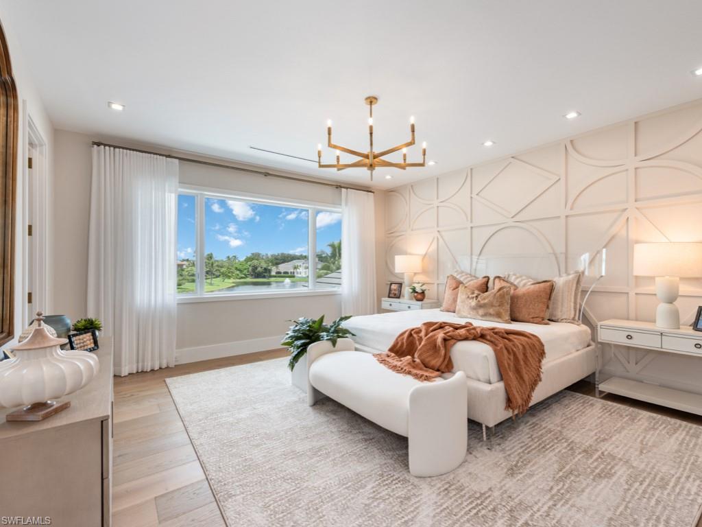 349 Colony Drive Naples, FL 34108 - Photo 31 of 48 Bedroom featuring light wood-type flooring and a chandelier