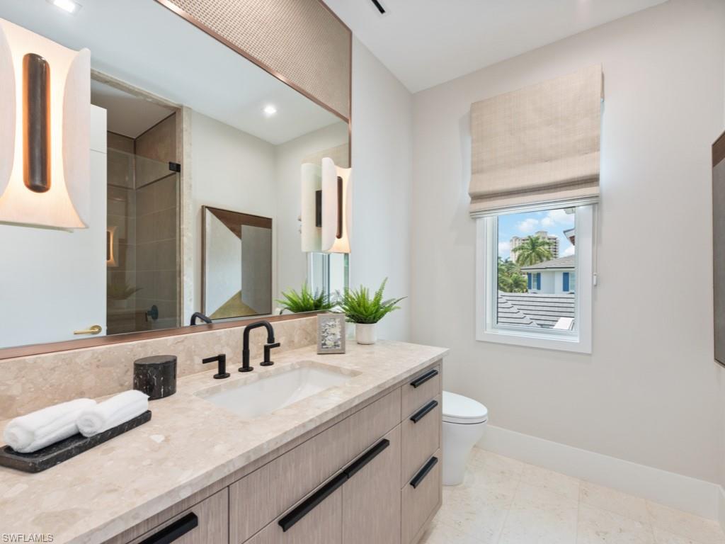 349 Colony Drive Naples, FL 34108 - Photo 32 of 48 Bathroom with vanity, toilet, an enclosed shower, and tile patterned floors