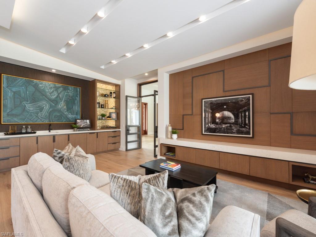 349 Colony Drive Naples, FL 34108 - Photo 39 of 48 Living room with a barn door, light wood-type flooring, and sink