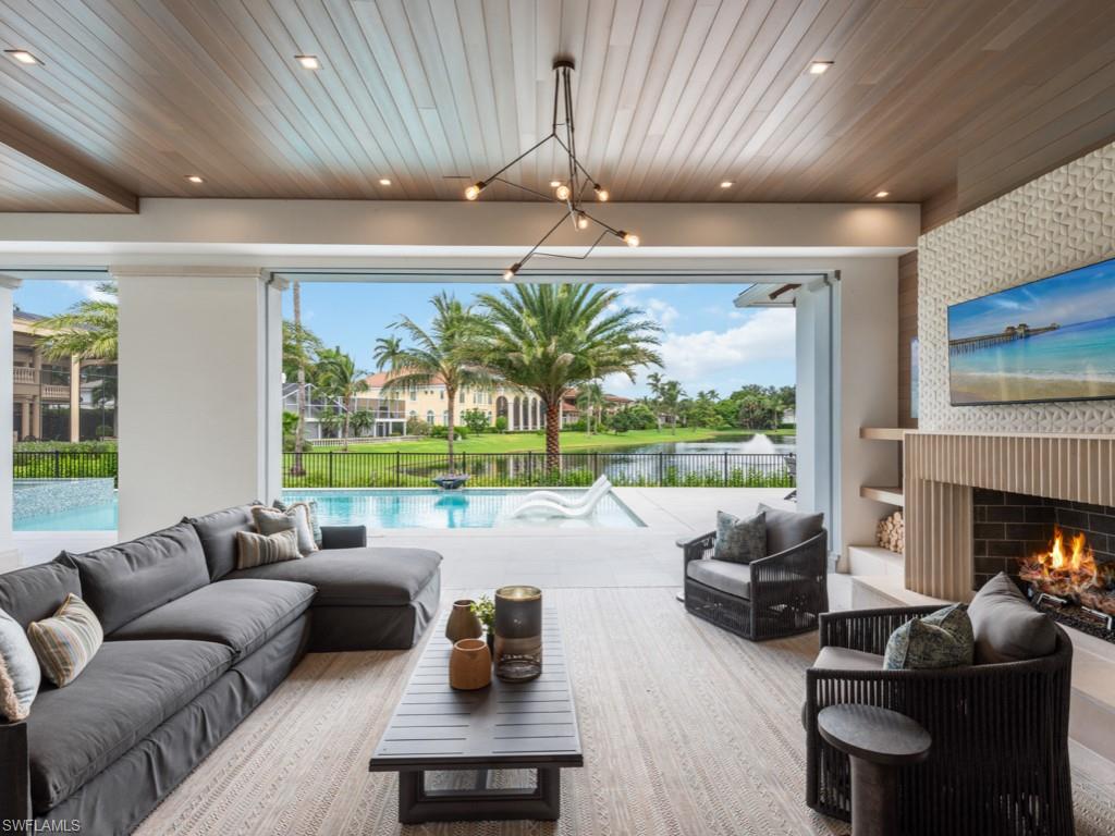 349 Colony Drive Naples, FL 34108 - Photo 41 of 48 Living room featuring wood ceiling and a notable chandelier