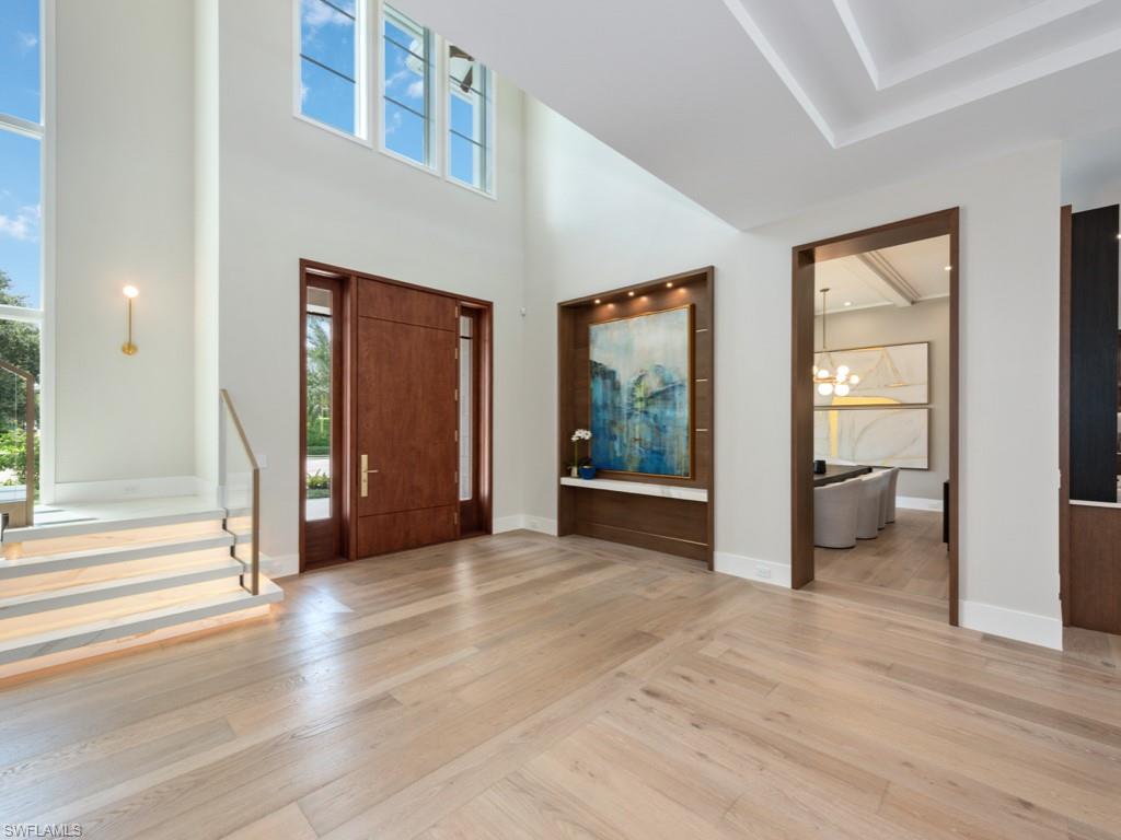 349 Colony Drive Naples, FL 34108 - Photo 10 of 48 Foyer entrance featuring light wood-type flooring, a wealth of natural light, and a notable chandelier