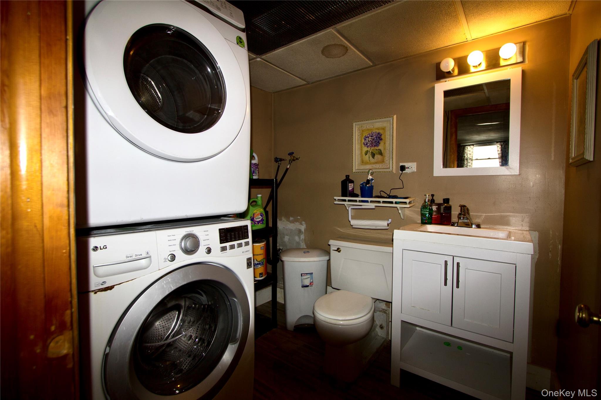 182 Downing Road Pleasant Valley, NY 12569 - Photo 13 of 29 Half bathroom featuring vanity, stacked washer and dryer.