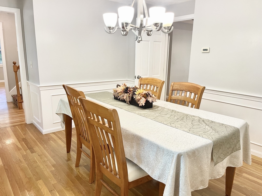 42 Jackson Drive Acton, MA 01720 - Photo 17 of 39 a dining room with furniture and chandelier