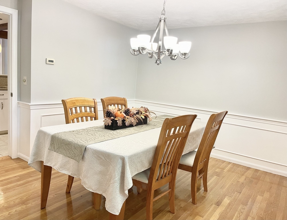 42 Jackson Drive Acton, MA 01720 - Photo 18 of 39 a view of a dining room with furniture and chandelier