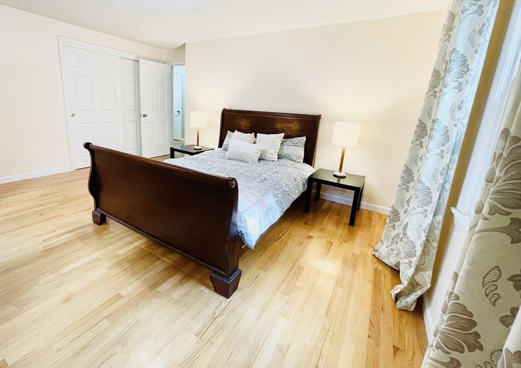 42 Jackson Drive Acton, MA 01720 - Photo 21 of 39 a bed sitting in a bedroom next to a small yard