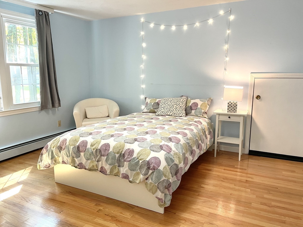 42 Jackson Drive Acton, MA 01720 - Photo 27 of 39 a large white bed sitting in a room next to a window