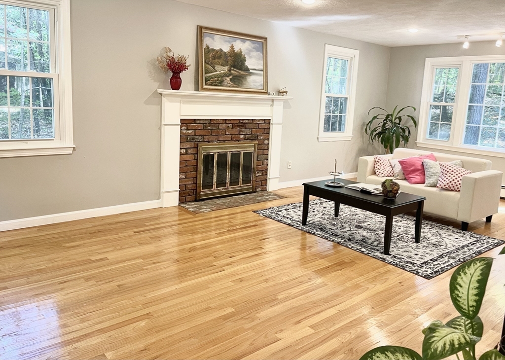 42 Jackson Drive Acton, MA 01720 - Photo 4 of 39 a living room with furniture and a fireplace