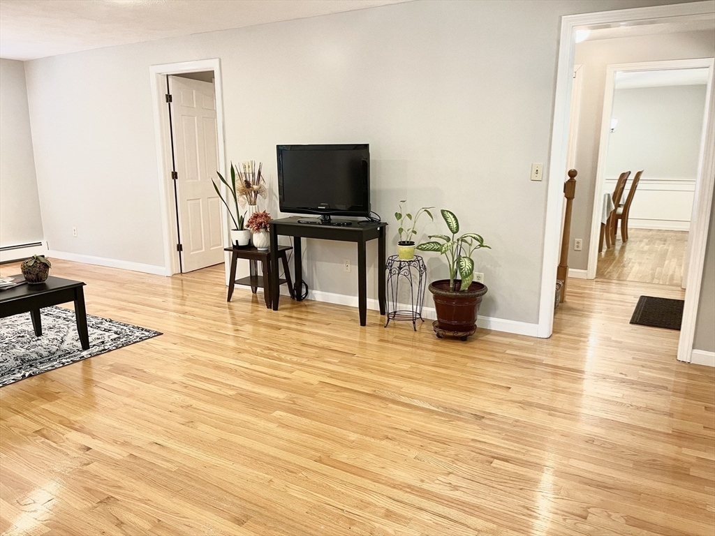 42 Jackson Drive Acton, MA 01720 - Photo 6 of 39 a living room with furniture and a flat screen tv