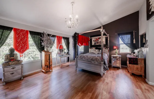 a bedroom with furniture and a chandelier