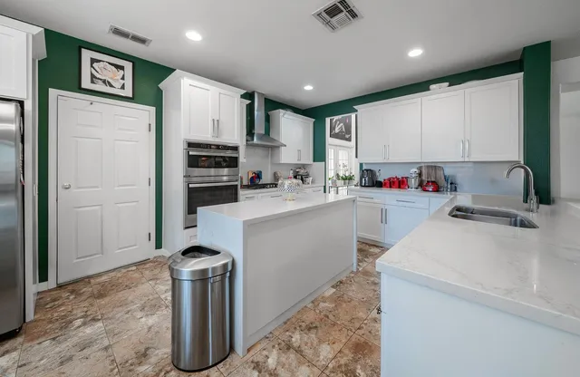 a kitchen with a sink stove and refrigerator