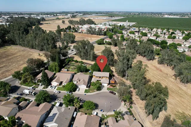 an aerial view of residential houses with outdoor space and river
