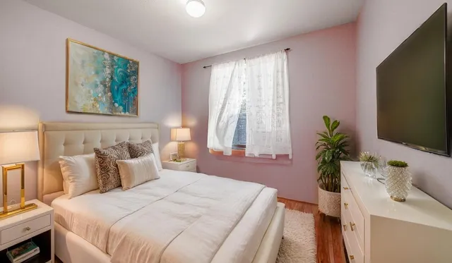 a bedroom with a bed and a window