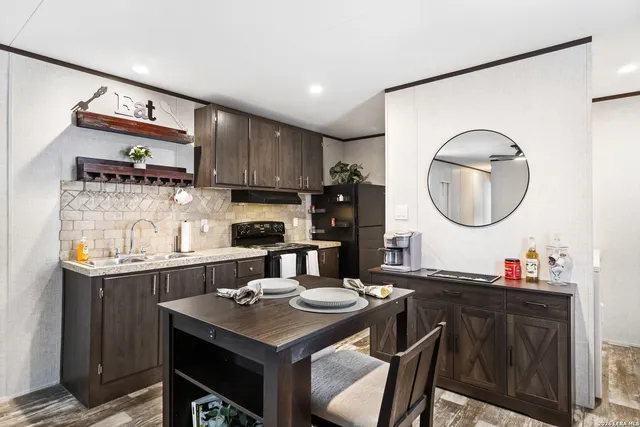 a kitchen with a sink a stove and chairs