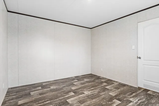 a view of a room with wooden floor