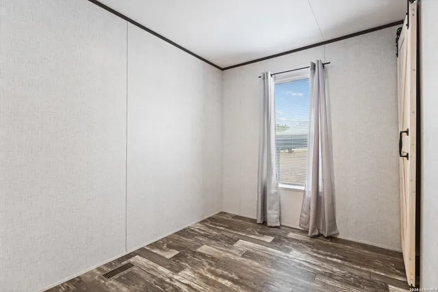 a view of a room with wooden floor