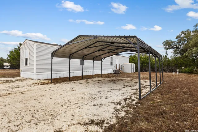 a view of wooden fence and a yard