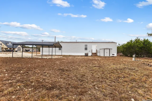 a view of house with yard and dinning area
