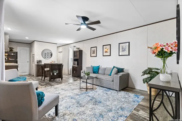 a living room with furniture a fireplace and a potted plant