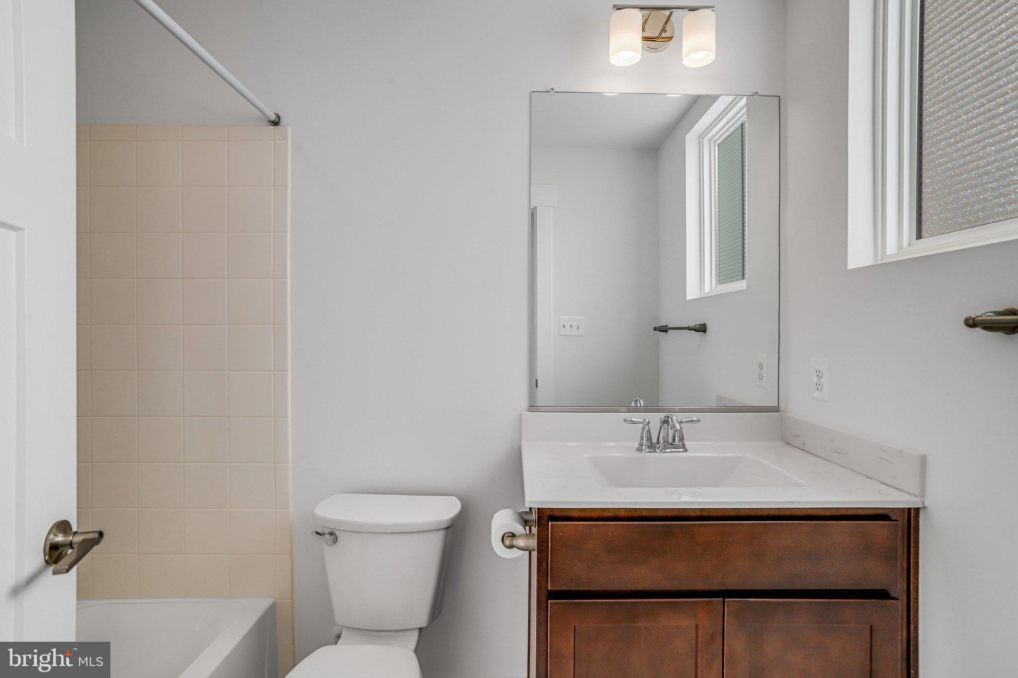 1203 Furgeson Lane Frederick, MD 21702 - Photo 11 of 16 a bathroom with a sink toilet and mirror