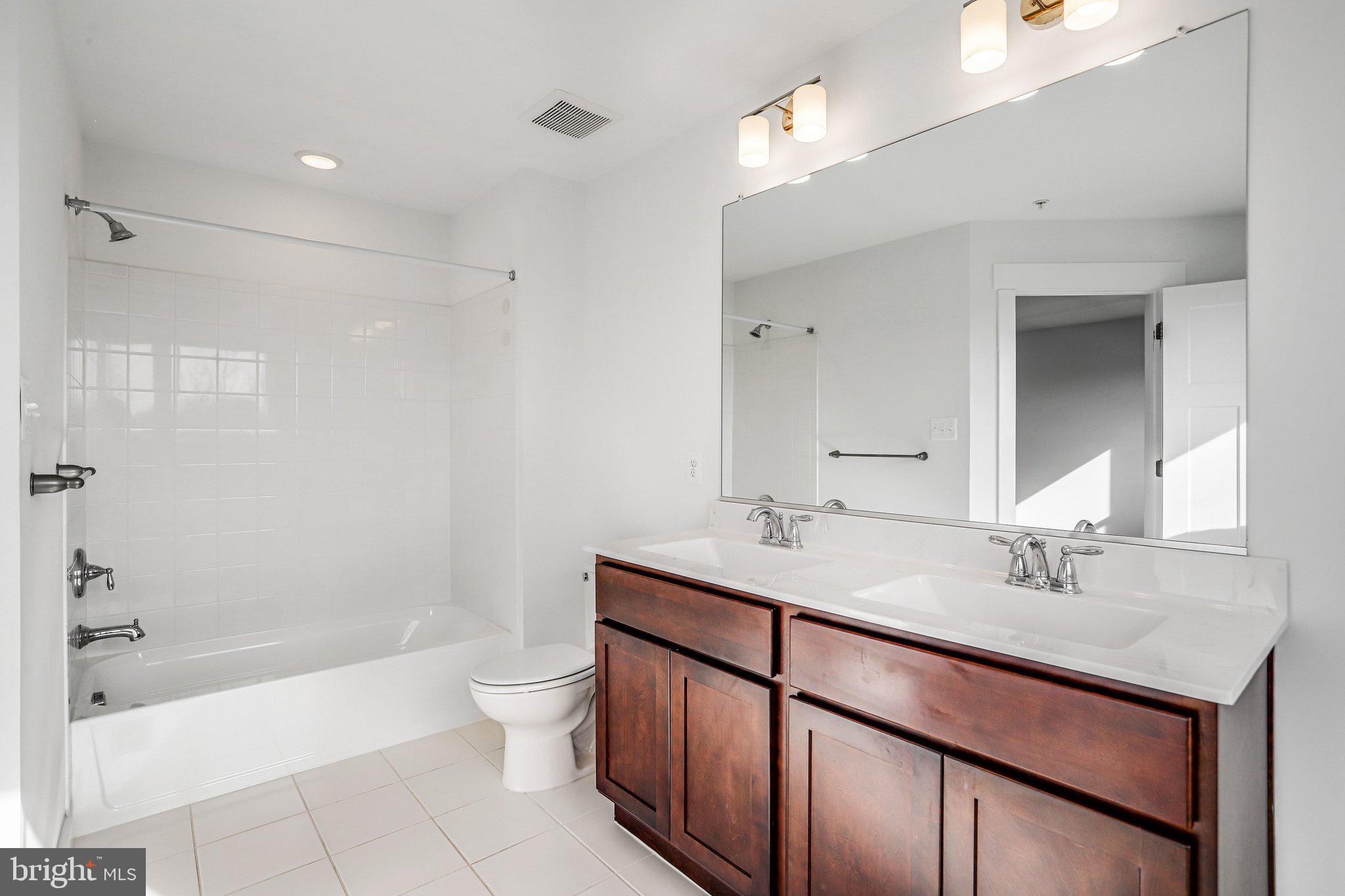 1203 Furgeson Lane Frederick, MD 21702 - Photo 12 of 16 a bathroom with a sink a toilet and shower