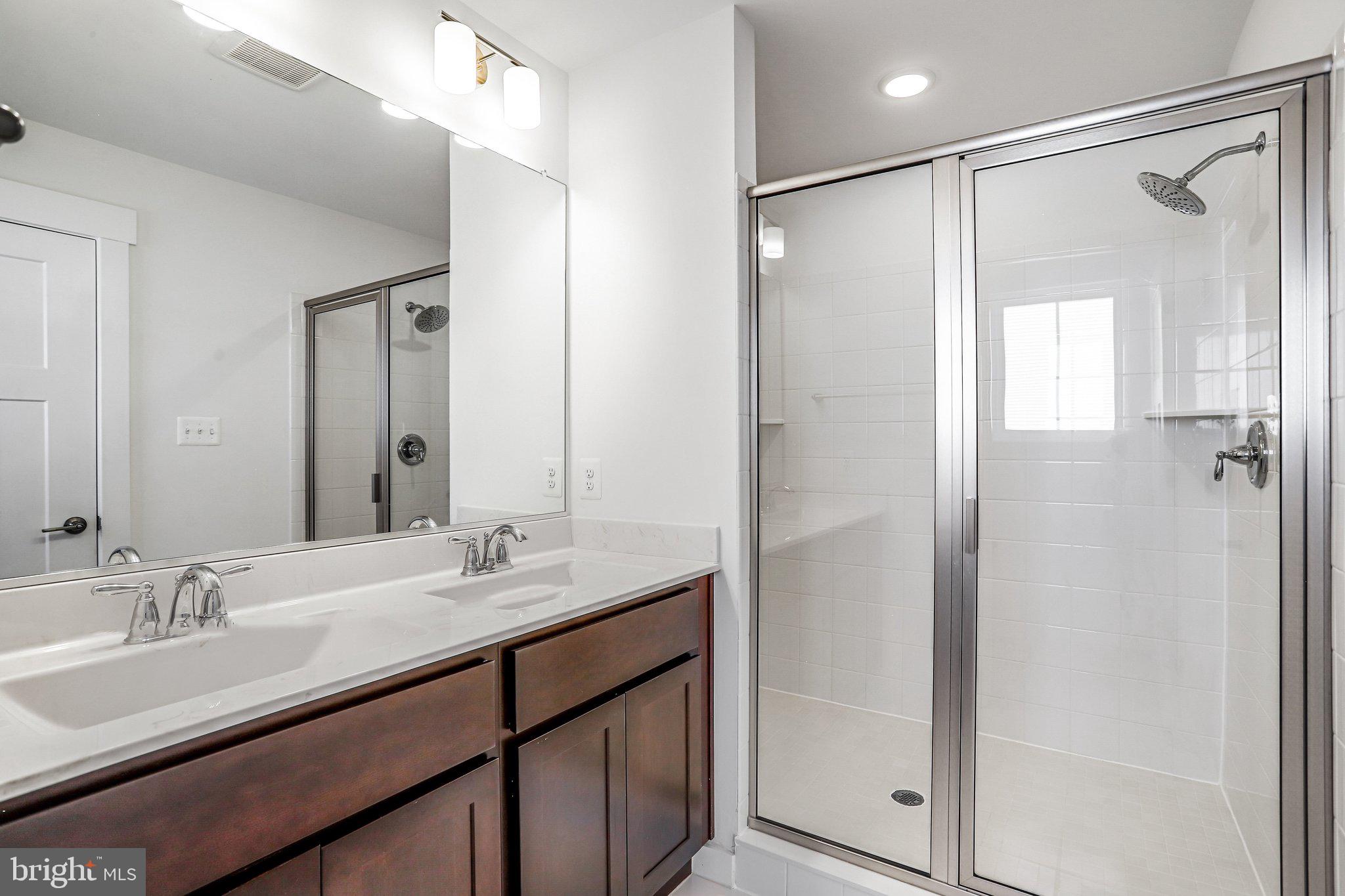 1203 Furgeson Lane Frederick, MD 21702 - Photo 10 of 16 a bathroom with a granite countertop sink mirror and double