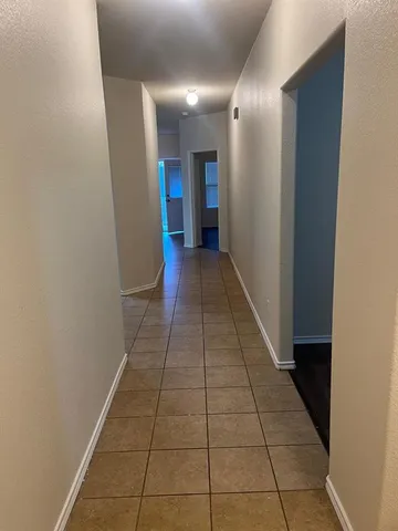 a view of hallway with a window and a glass door